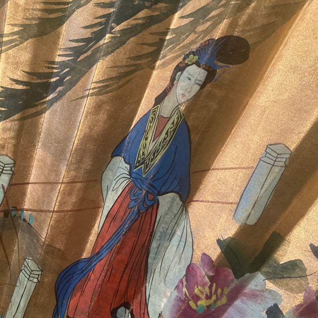 This extraordinary, monumental mid-century Asian folding wall fan is a masterclass in Hollywood Regency and Chinoiserie...
