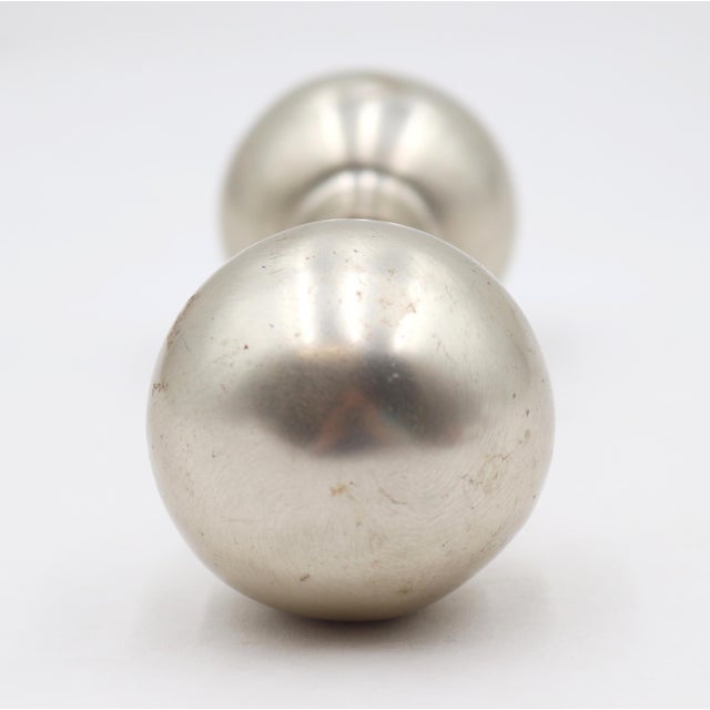 Modern style passage ball shaped door knobs made of brass with a brushed chrome finish. Good condition with surface wear...