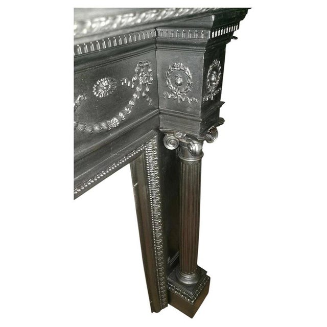 A magnificent and substantial victorian cast iron fireplace surround, finely executed in the neoclassical manner and...