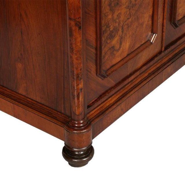 An exceptional italian late umbertino dressing cabinet crafted in solid walnut and richly figured walnut burl, retaining...