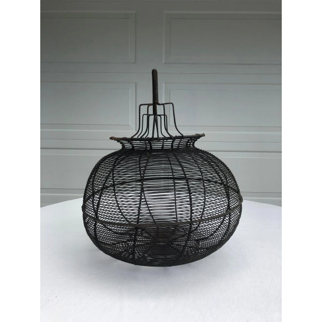 ENORMOUS wire mesh basket with fixed handle and metal feet. I can only estimate as I do not have a standardized basket of...