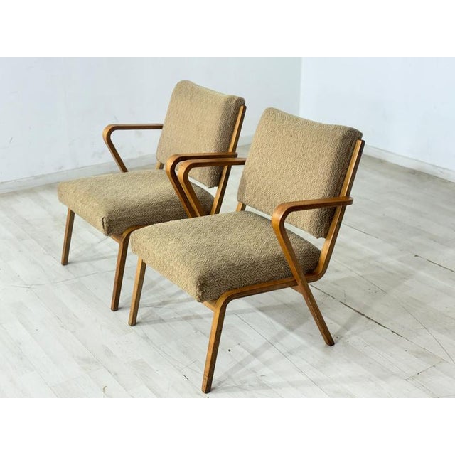 For sale are two stylish vintage armchairs from the 1960s. These armchairs impress with their clean lines, curved...