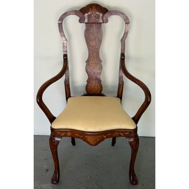 An elegant late 19th-century Dutch marquetry open armchair, beautifully crafted in richly figured mahogany with finely...