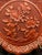 A stunning example of red lacquer Chinese Cinnabar, featuring a high relief center cartouche of chrysanthemums, with...