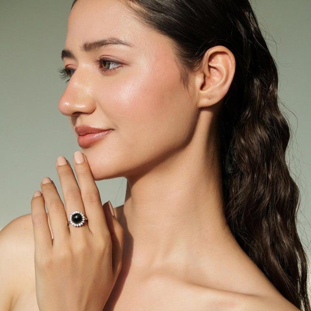 This contemporary Black Star and zircon halo ring is crafted in 925 sterling silver, featuring a 10 mm centerpiece with a...