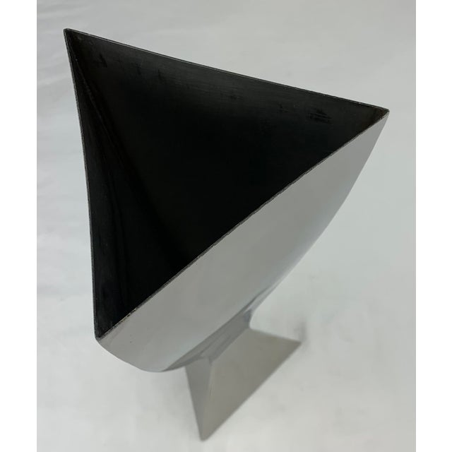 A set of. 2 contemporary polished Chrome plated vases Comprised of bent sheet metal molded into a Biomorphic shape....