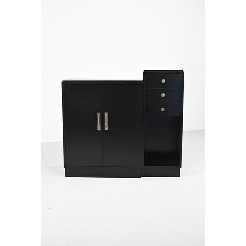 Art Deco style cabinet, lacquered in black and with beautiful, we think nickel plated, handles. This cabinet has light...