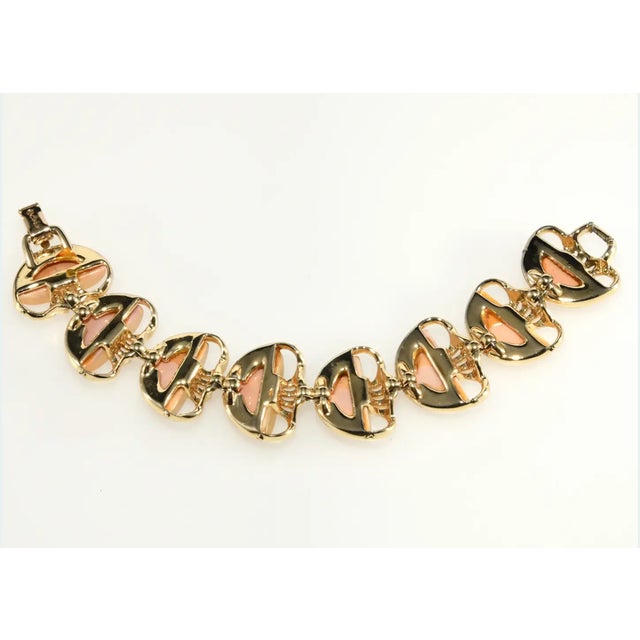 Coro bracelet decorated with confetti Lucite segments that look like simulated opals with sparkling green glitter within...