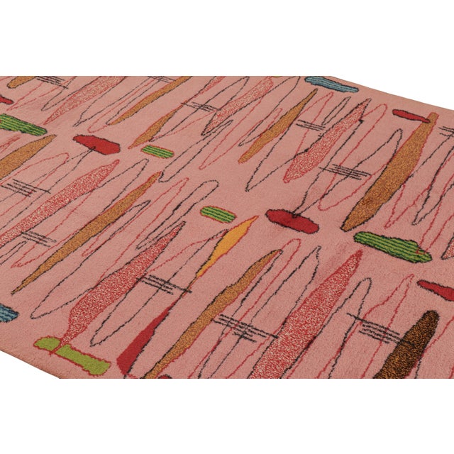 Hand-knotted in wool, this 5x8 vintage rug originating from Turkey, circa 1960-1970, is a very special piece, featuring a...