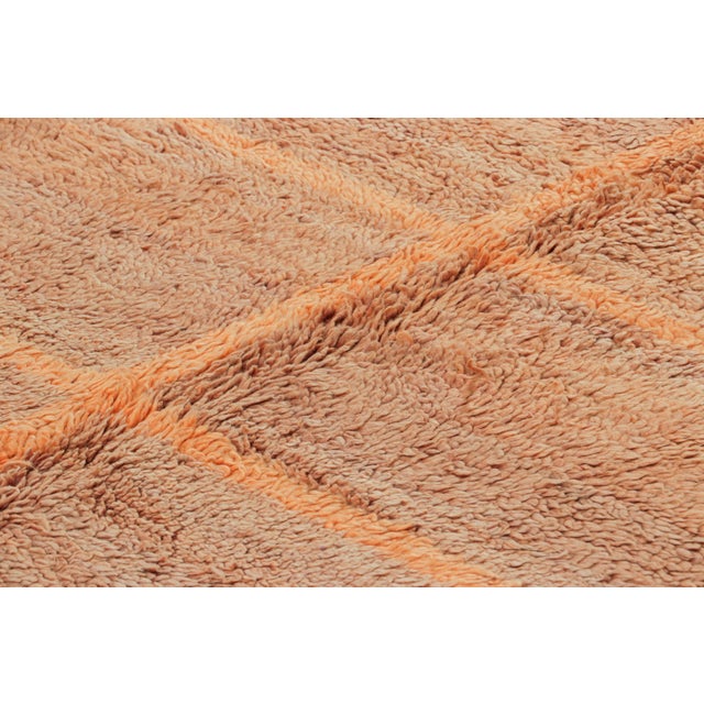 Hand-knotted in wool and originating from Morocco circa 1950-1960, this 7x8 vintage rug is a rare and among the most...