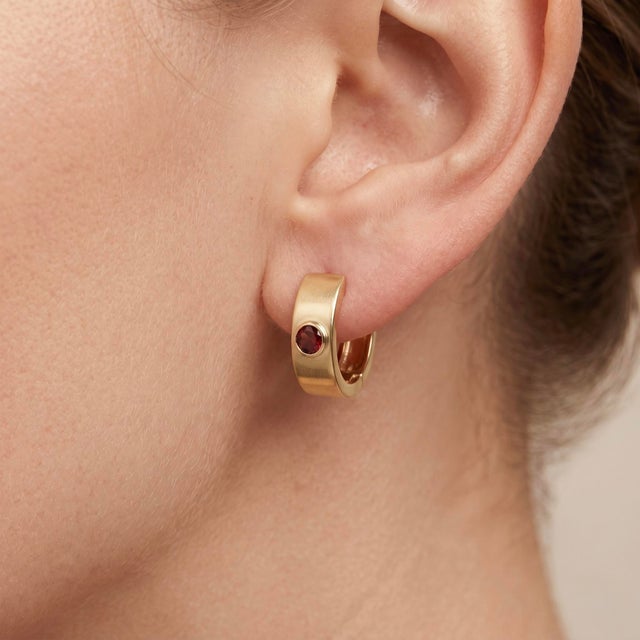 Elevate your everyday look with these sophisticated and modern huggie hoop earrings. Expertly crafted with a wide,...