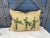 A pillow newly made from a circa 1880s printed cotton, backed and edged with a coordinating raw silk, with a grosgrain...