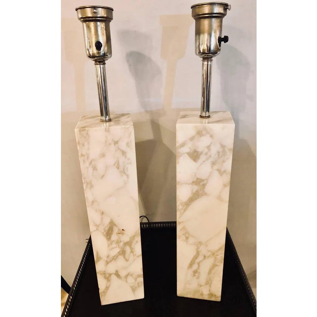 A Fine Custom Pair Of Mid Century Modern Robsjohn Gibbings White and Gray veined Marble Column Form Table Lamps. The...