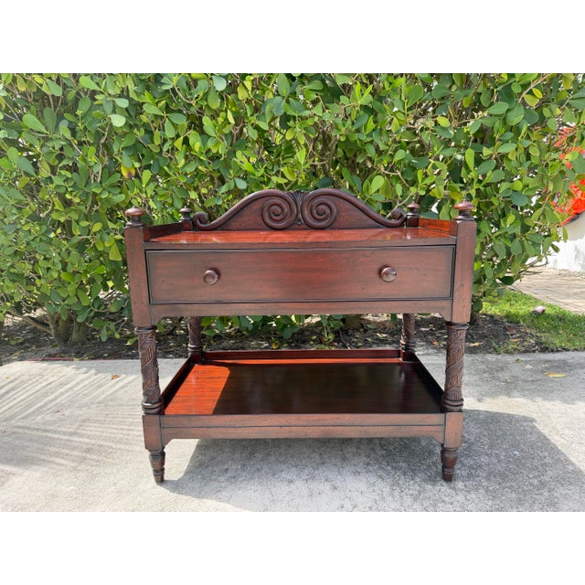 Vintage Ralph Lauren mahogany two-tier server featuring a shaped gallery back with carved scroll detailing, a spacious...