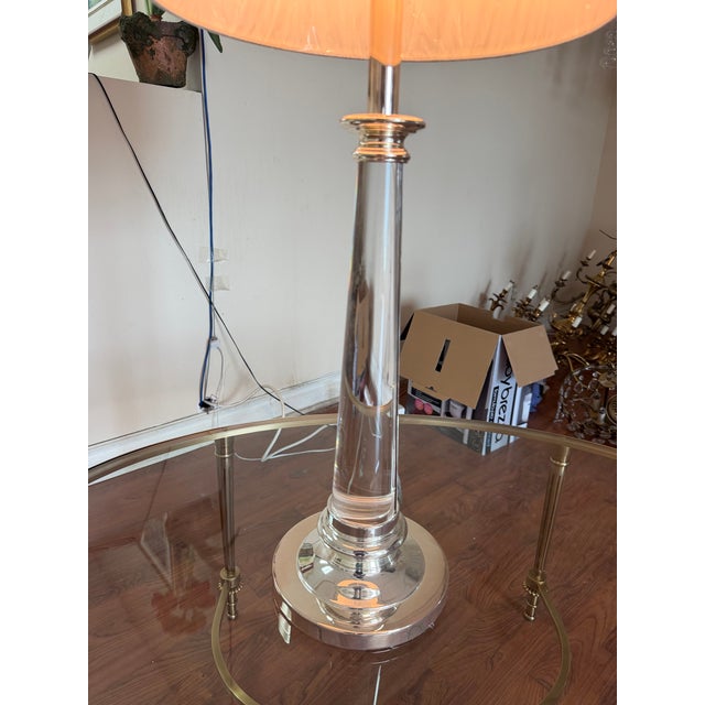 A Haig table lamp featuring a polished brass-plated nickel finish, paired with a solid Lucite centre stem for a clean,...