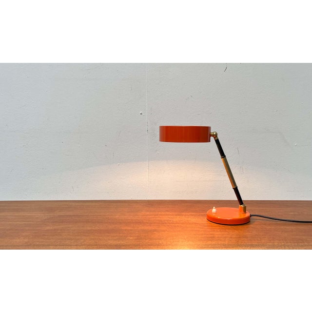 Mid-century Italian table lamp. The minimalist shade is a striking feature. The shade and base share a similar design...