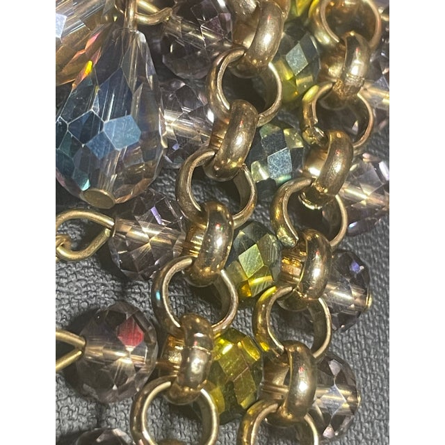The construction is built on a heavy-gauge, gold-tone rolled-wire chain mail framework made from interlocking, thick jump...