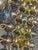 The construction is built on a heavy-gauge, gold-tone rolled-wire chain mail framework made from interlocking, thick jump...