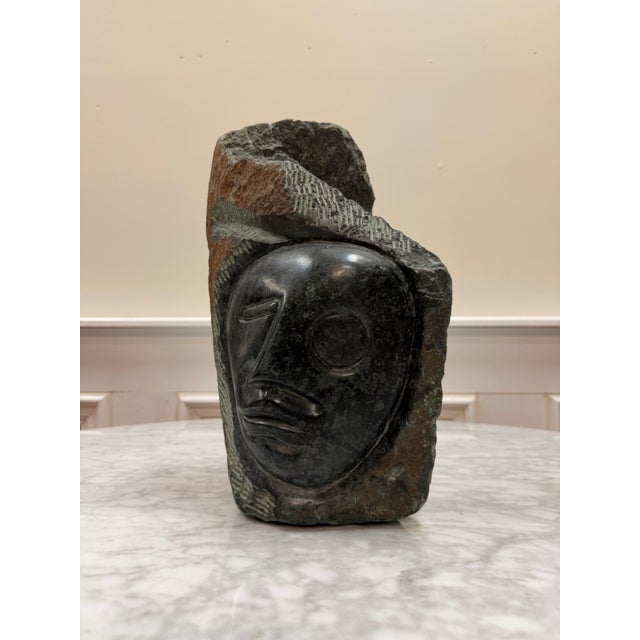 A powerful, authentic hand-carved stone face sculpture from the internationally celebrated Shona art movement. Masterfully...