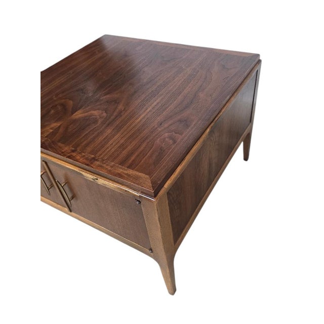 A handsome vintage Lane Furniture cabinet end table showcasing beautifully figured bookmatched walnut veneer, sculptural...
