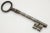 Large four inch antique European steel gate or chateau skeleton key with harp head and well-defined teeth attached to a...