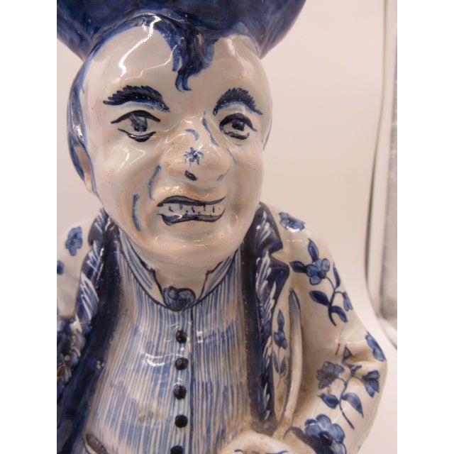 A pair of verry unusual Dutch/Delft blue and white tobys. They are 18th Century with a maker's mark on the under side....