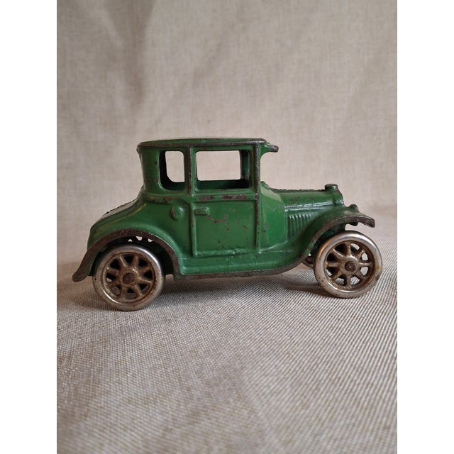 An Exceptional "As-Found" Early 1920s American Cast Iron Toy Offered is an antique cast iron Ford Model T Coupe...