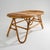 A 1950s wicker coffee table that naturally reflects the period's appreciation for light, informal furnishings designed to...