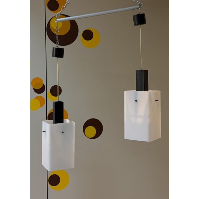 Stilux milano\. Set of two 1960s pendant lamps the electric cable directly supports the white opaline glass lampshade,...