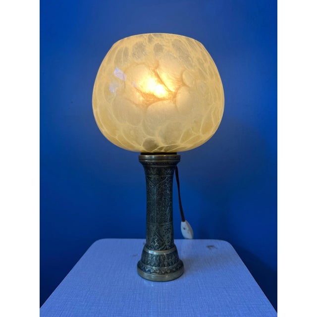 Art nouveau table lamp with golden base and glass shade. The lamp requires one E14 lightbulb and currently has an EU-plug....