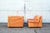 Pair of Bonheur armchairs with leather-covered padding and plastic base. Designed by Titina Ammannati and Giampiero...
