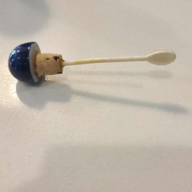 This hand-painted porcelain snuff bottle is a sophisticated addition to a collection or a modern shelf arrangement....