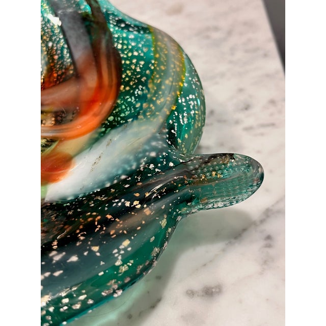 Leaf shaped art glass with a beautiful swirl of colors and metallic flecking. A unique and fun piece! Attributed to...