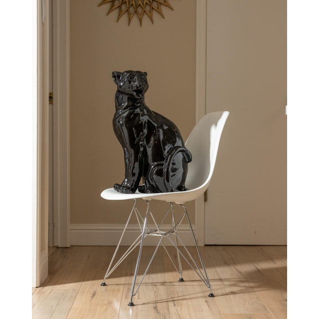 Large vintage ceramic panther sculpture finished in a deep, high-gloss black glaze. The seated form has a strong...