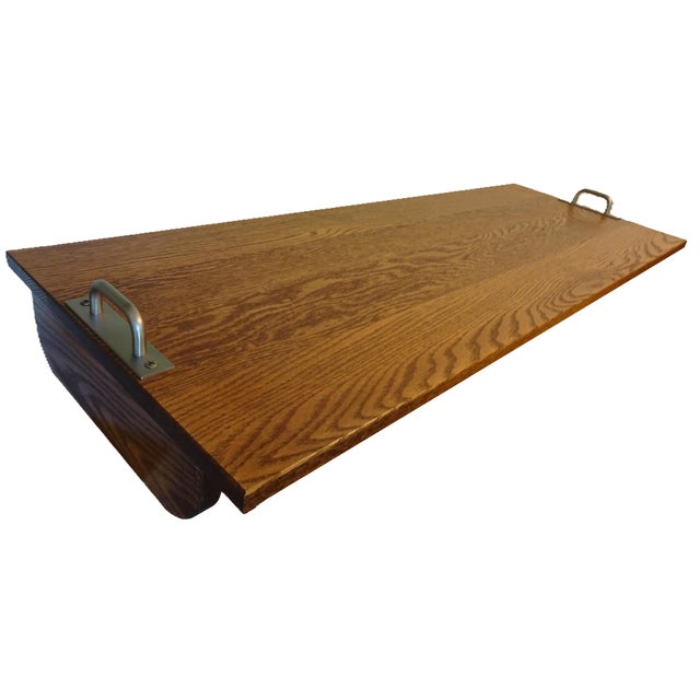 This tray table will accommodate most easy chairs. It's made of oak and sets across the chair arms for a variety of...