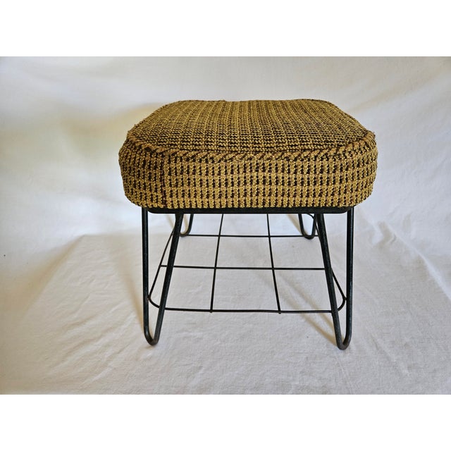 A Nice MCM Upholstered Wrought Iron Foot Stool featuring Hairpin legs and an underneath metal grid shoe holder. All original.