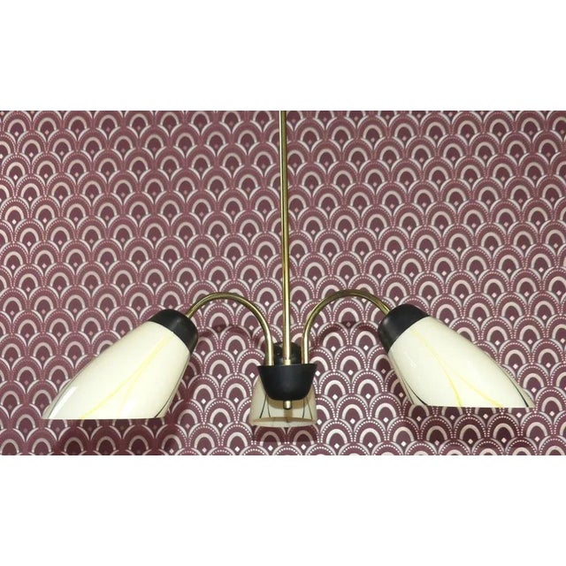 Beautiful 1950s ceiling lamp The three elegant cone-shaped shades are made of glass with an attractive black and yellow...