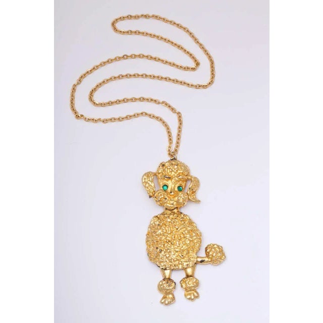 This is part of Chairish’s Costume Jewelry assortment. Large green eyed poodle pendant necklace. Poodle is 4.5" high x...