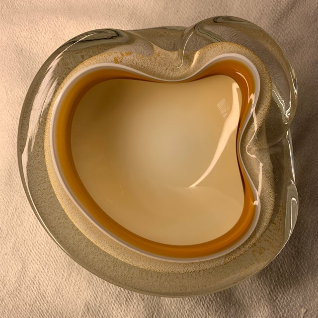 This item is a vintage mid-century Murano art glass bowl or ashtray, featuring an organic, biomorphic shape typically...