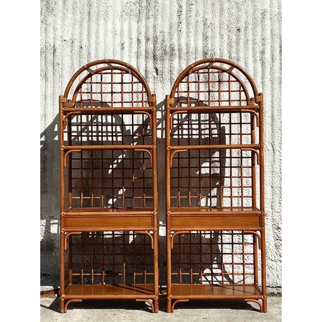 Add a touch of breezy coastal charm to your space with this stunning pair of vintage rattan etageres. Featuring an elegant...