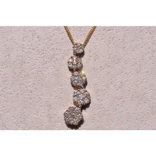 The 97th Street: Natural Diamond Journey Pendant in Yellow Gold. The necklace features mystery set round brilliant cut...