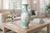 Elegant 10-inch porcelain vase featuring a vibrant turquoise ground with a raised, textured pattern that catches the light...
