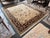 Design Plus Gallery presents a 7ft 10in x 9ft 11in Area Rug. The rug has a thick, deep plum border with brightly toned...