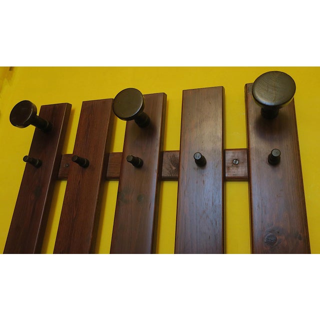 Mid century large wall mounted coat and hat rack in stained wood, 1960s, with 3 large coat holders and 10 smaller ones.