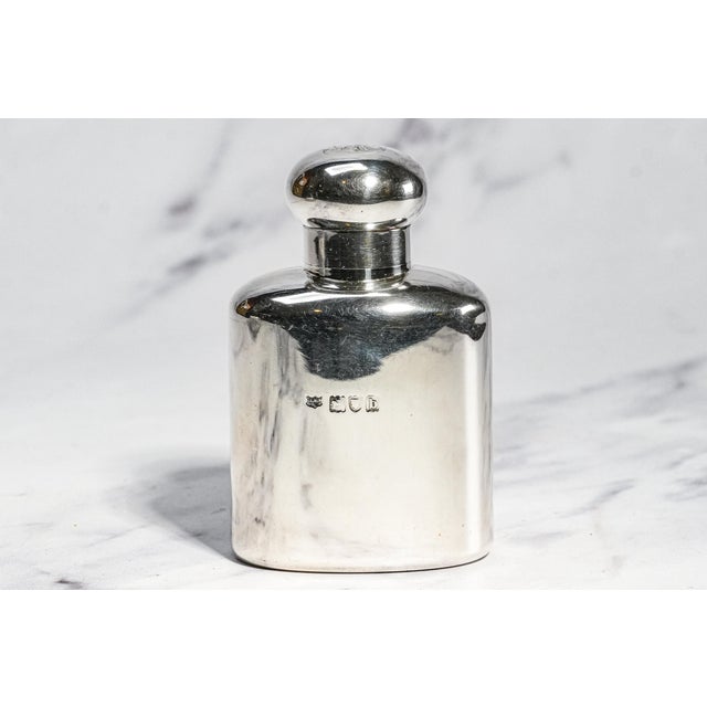 An elegant example of late Victorian luxury, this antique sterling silver scent bottle was crafted by the celebrated...