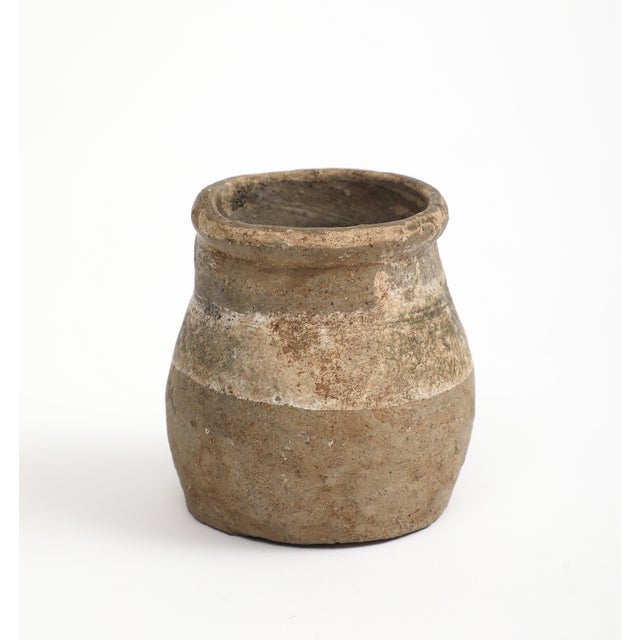Two small ancient Chinese pottery jar vessels. Striations of colors. Taller: 3" H x 2.25" diameter Smaller: 2.5" H x 2"...