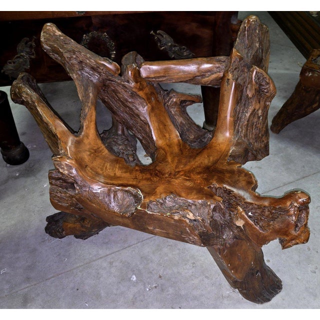 A sculptural piece, this solid wood seat is crafted from a natural root or stump, meticulously worked and polished. this...