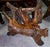 A sculptural piece, this solid wood seat is crafted from a natural root or stump, meticulously worked and polished. this...