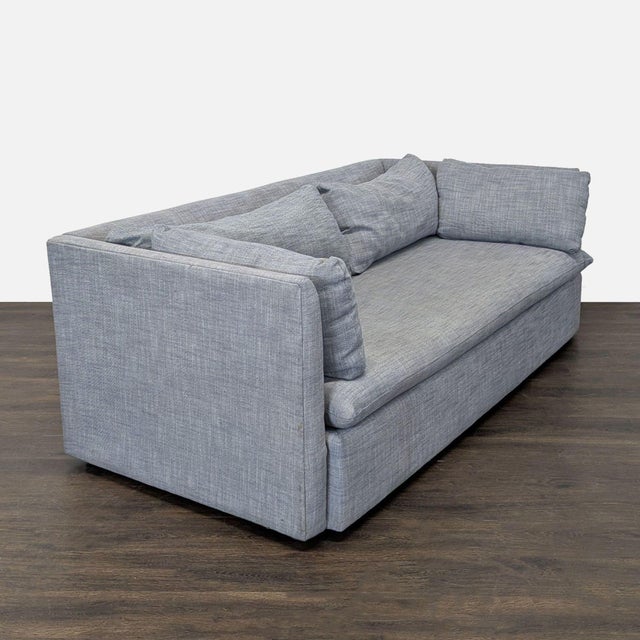 This West Elm 3-seat sofa features a modern design with clean lines and a stylish gray fabric. It includes plush, loose...