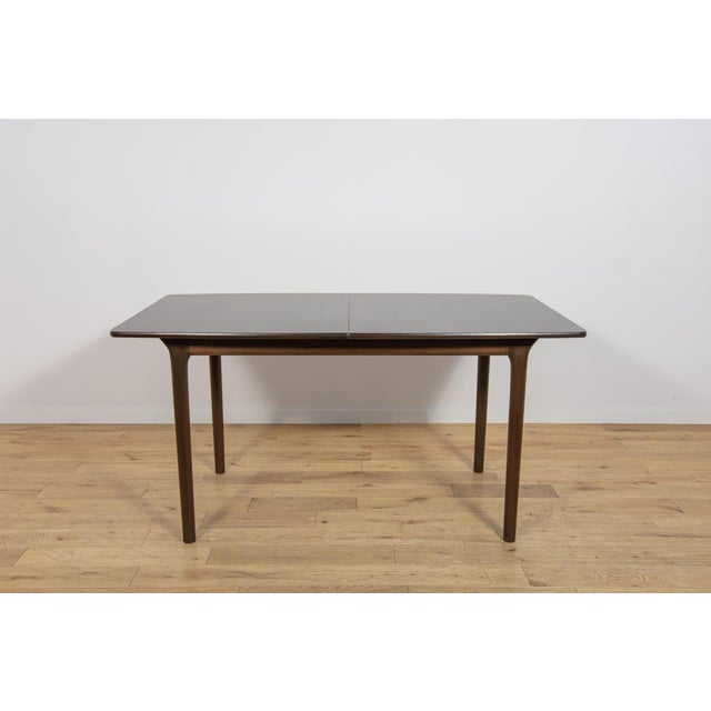 This extending dining table was manufactured by the Scottish furniture maker A.H. McIntosh & Co. during the 1960s. The...
